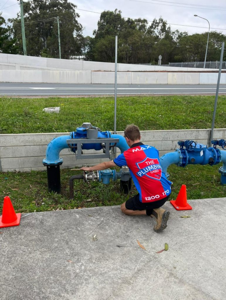 plumber fixing leaking pipe emergency