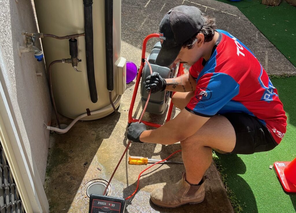 plumber fixing the hot water system